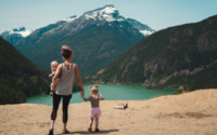 Travelling mother gazing at lake with toddler and baby. Photo by Josh Willink from Pexels