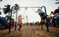 Children on swings in a playground. Photo by cottonbro from Pexels